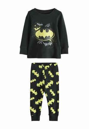Set de pijama din bumbac negru, cu un top cu mânecă lungă, având un logo galben Batman și un design cu stropi, completat cu pantaloni asortați ce au motive de bătușe galbene.