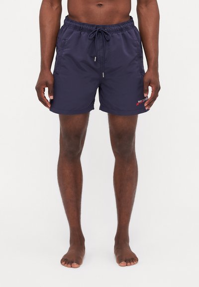 Shorts de bain navy en tissu léger avec une taille élastique et un cordon de serrage. Détails du logo près de l'ourlet et coupe relaxée.