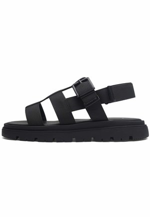 Sandal nero con ampie cinghie in tessuto, fibbia regolabile, suola anatomica, intersuola testurizzata e un motivo di battistrada robusto.