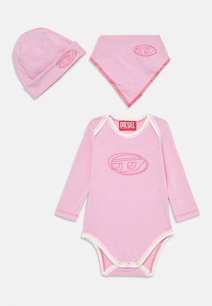 Pink baby outfit set featuring a long-sleeve bodysuit, hat, and bandana. Soft cotton fabric; logo detail in a matching pink outline.