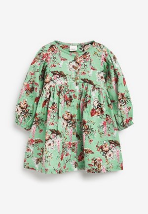 Groene bloemenjurk van lichtgewicht stof; heeft lange mouwen, een ronde hals en houten knopen, met een gelaagde rok en een geraffineerde taille.