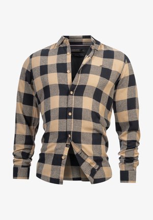 Kockovaný košeľový top v béžovej a námorníckej modrej farbe, vyrobený z jemnej látky, s dlhými rukávmi a klasickým golierom, s drevenými gombíkmi.