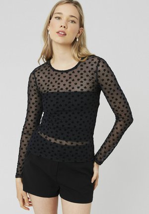 Haut à manches longues en maille noire avec des broderies en forme d'étoile sur le devant et les manches, avec un col rond et une coupe ajustée.