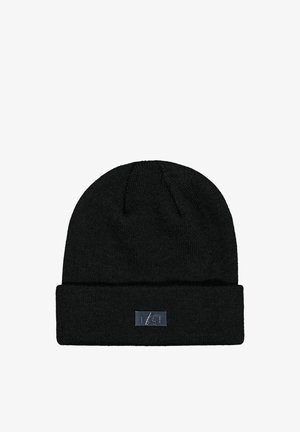 Black knitted winter beanie with a folded brim and a small rectangular metal brand logo on the front center.