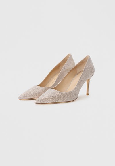 Beige high-heeled pumps with a pointy toe and textured fabric. Slim stiletto heel with a smooth inner lining. Simple design, no embellishments.