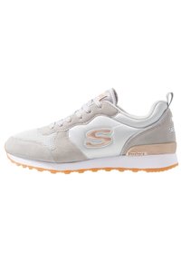 Light grey and white sneaker with suede and mesh materials, orange outsole, and a subtle logo on the side. Lace-up design with padded collar.