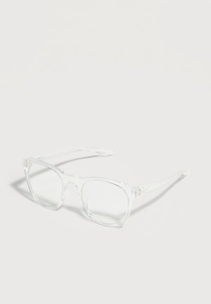 Clear transparent square eyeglass frames with slightly rounded edges and visible hinges resting on a plain light surface.