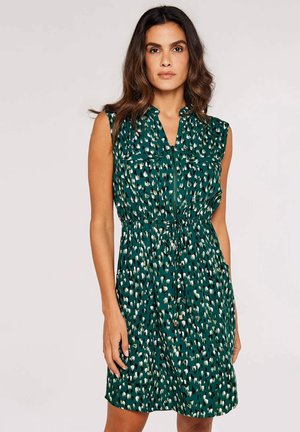 Grünes Musterkleid mit Reißverschluss vorne, ärmellosem Design, tailliert und zwei Brusttaschen. Merkmale ein Spritzdesign in hellen Farben.