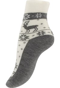 Chaussettes en tricot avec un dessus crème orné de motifs de rennes et de flocons de neige gris. Semelle texturée grise. Longueur cheville avec un bord côtelé.