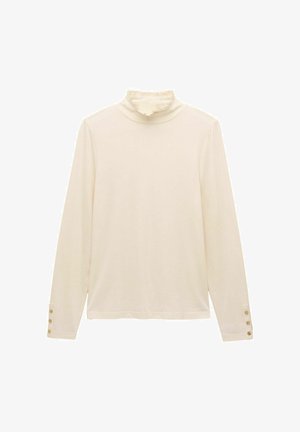 Crème lange mouwtop met gerimpelde hoge kraag en drie kleine gouden knopen op elke manchette, plat gelegd op een witte achtergrond.