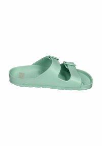 Mint green slide sandals made of soft, textured material. Features two adjustable buckles and a contoured footbed for comfort.