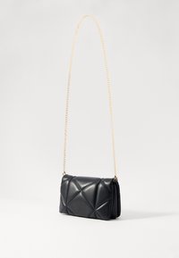 Borsa a tracolla nera in pelle, caratterizzata da un design trapuntato, una tracolla in catena dorata e una forma rettangolare con bordi morbidi.