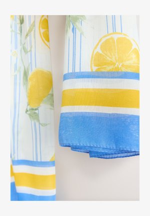 Bomullstyg med citron- och lövmönster, med blå och gula horisontella ränder. Kanterna är fållade med en rak söm.