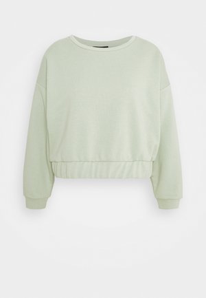 Sweat-shirt court vert clair à manches longues avec encolure ronde, taille élastique et poignets côtelés sur fond uni.
