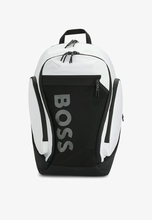 Black and white backpack with a sleek design, made of durable nylon. Features a large front pocket, mesh accents, and a logo in reflective print.
