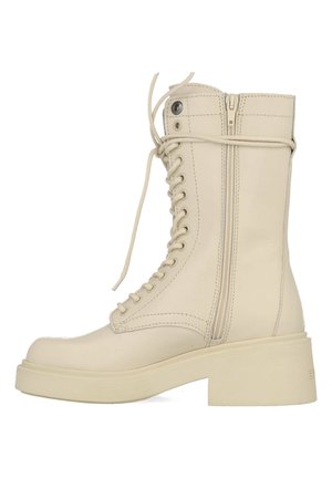 Cream-colored leather combat boots with a rounded toe, lace-up front, and side zipper. Features a chunky sole and stitch detailing.
