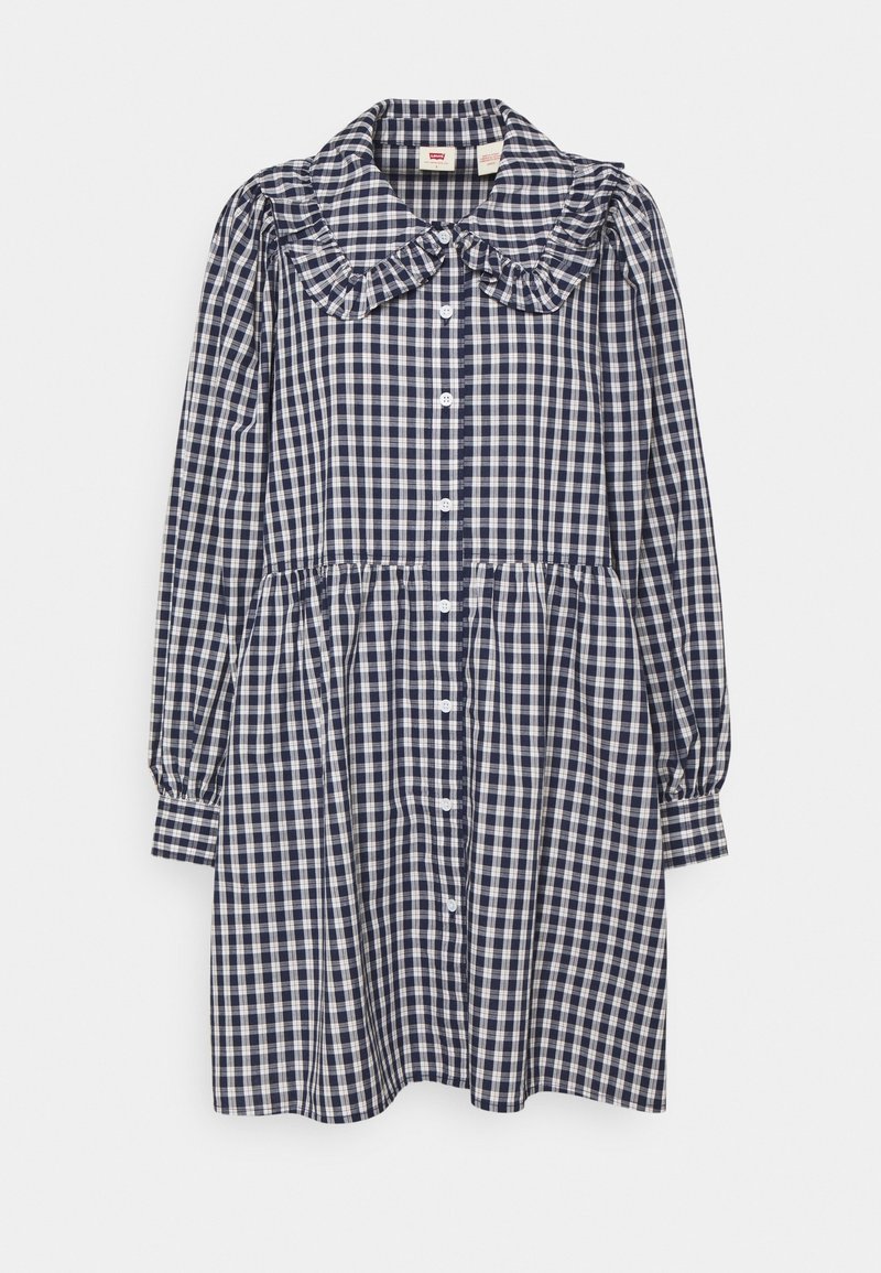 Robe à manches longues à carreaux bleu marine et blanc, avec boutonnage sur le devant, col à volants, taille froncée et manches retroussées.