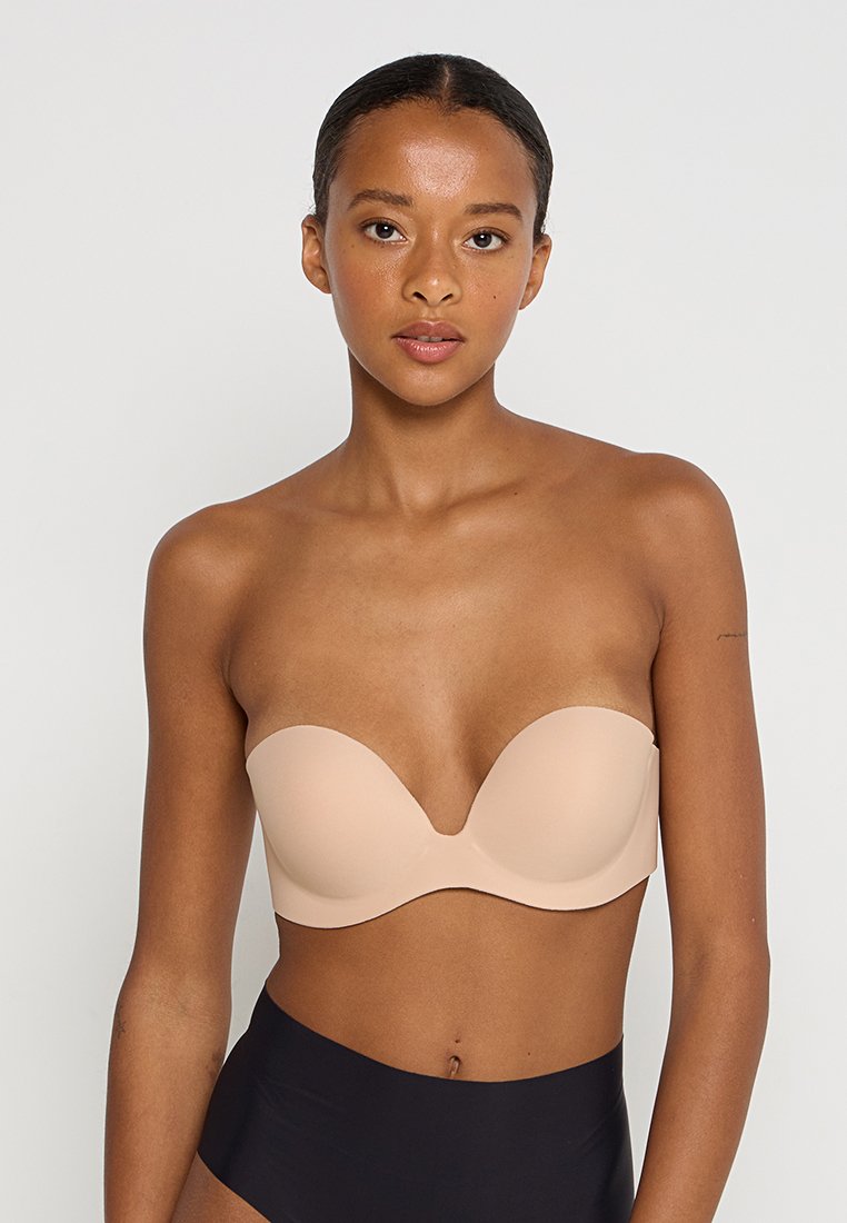 Soutien-gorge nude sans bretelles avec un design lisse et moulé. Doté d'une forme incurvée et sans couture, il offre une texture douce pour le confort.