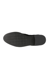 Suola di scarpa nera con una presa testurizzata e a motivi, e bordi lisci. Presenta un design piatto e dettagli del marchio incisi vicino al tallone.