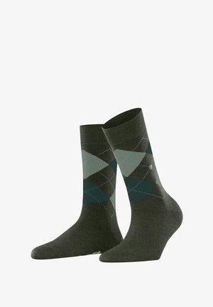 Grüne Socken mit einem Argyle-Muster in dunklen und hellen Grüntönen. Aus einem Stoff mit einem gerippten Bund und verstärkter Spitze.