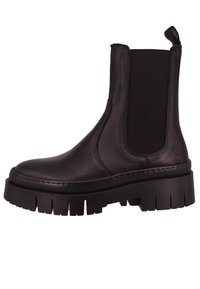 Botas Chelsea de cuero negro con paneles elásticos en los lados, una suela de goma gruesa y estriada, y una lengüeta en la parte posterior para ponerse fácilmente.