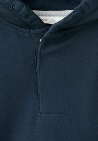 Navy blue hoodie made of soft fabric, featuring a half-button placket and textured hood. Clean lines and minimal detailing.