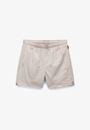 Korte beige shorts lavet af tekstureret stof, med en elastisk talje og sidelommer. Subtile mønstre og logo vist på forsiden.