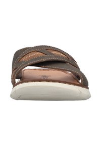 Brown leather slide sandal with cross-stitched straps, padded footbed, and a white rubber sole. Features a textured upper and stitching details.