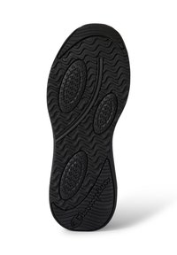 Black rubber shoe sole with a wavy pattern, textured indentations for grip, and a Champion logo in raised lettering along the edge.