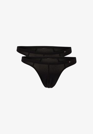 Sort stringtrusser lavet af blødt stof, med et minimalistisk design og smalle sider samt en fremtrædende søm for struktur.