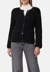 Schwarzer strukturierter Cardigan mit langen Ärmeln, Rundhalsausschnitt, Knopfverschluss und zwei Vorderstaschen. Weiches Material mit einem gemütlichen Erscheinungsbild.
