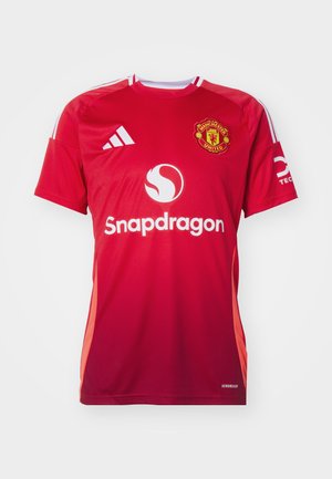 Röd fotbollsjersey med korta ärmar, vita detaljer och Manchester United-logotyp. Har Snapdragon-logotyp och Aeroready-detaljer.