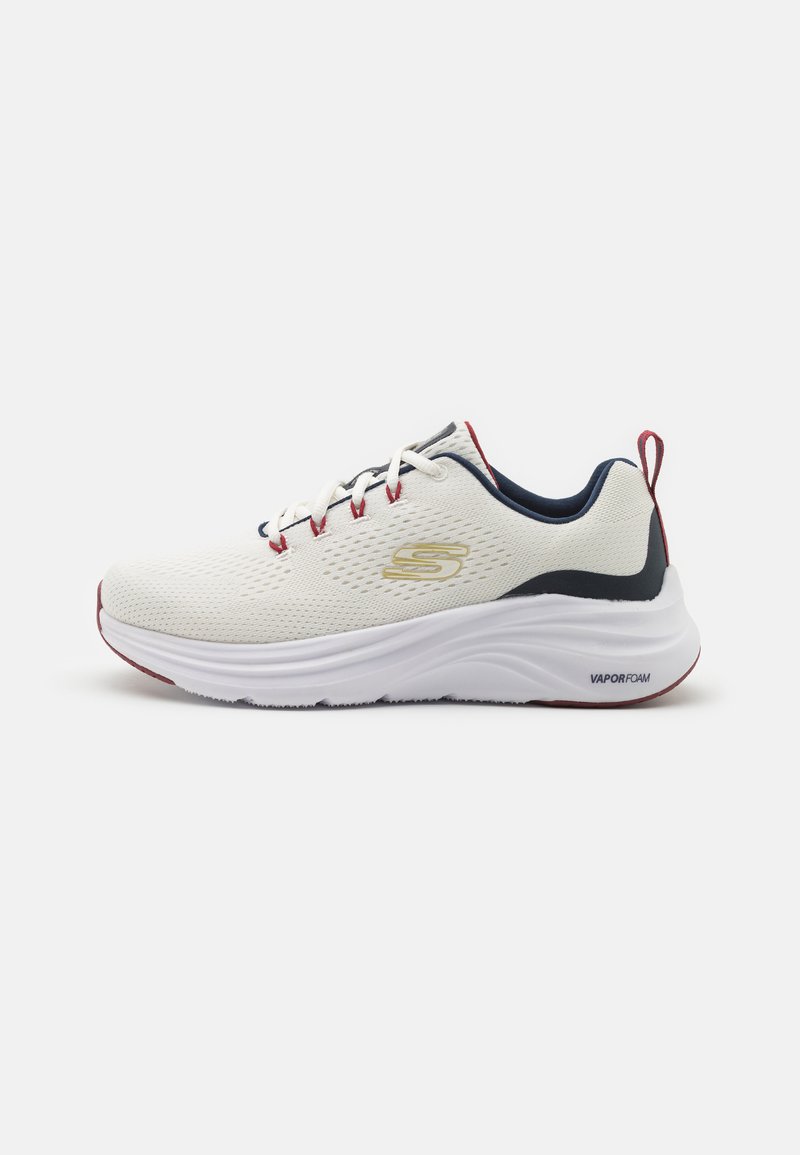 White athletic shoe with mesh upper, navy and red accents, cushioned white sole labeled "VAPORFOAM," and traditional laces.