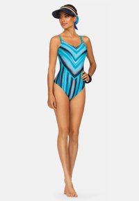 Jednoczęściowy kostium kąpielowy w odcieniach niebieskiego z wzorem w zygzak. Posiada cienkie ramiączka i gładki, elastyczny materiał.