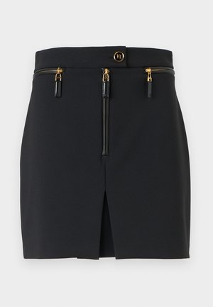 Black mini skirt with a structured fit, featuring gold hardware, two zippered pockets, and a front slit for added detail.