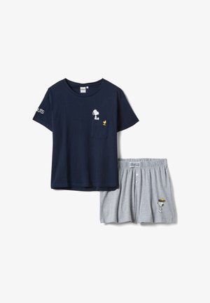 Navy blue short-sleeve top with Snoopy and Woodstock on pocket, paired with gray shorts featuring Snoopy wearing a nest with Woodstock.
