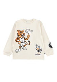 Pikad varrukad kreemjas särgis, millel on graafika tigrist spordivormis ja linnust, mõlemad hoides korvpalle. Mustad ja oranžid aksendid.