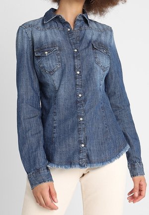Denim shirt with a button-up front, pointed collar, two chest pockets, and frayed hem. Dark blue color with a slightly faded texture.