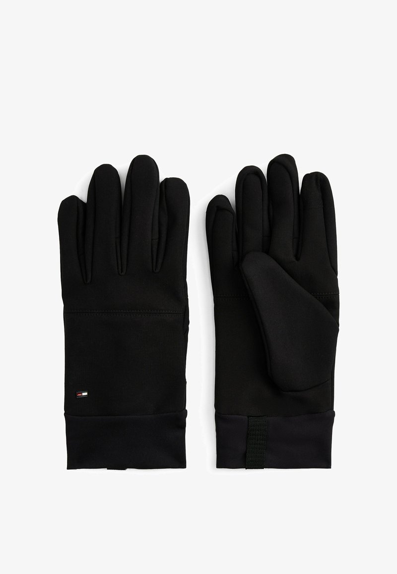 Zwarte handschoenen van zacht, rekbaar materiaal. Voorzien van een slank ontwerp, vijf vingers en een gestructureerde grip met een klein logo op de pols.