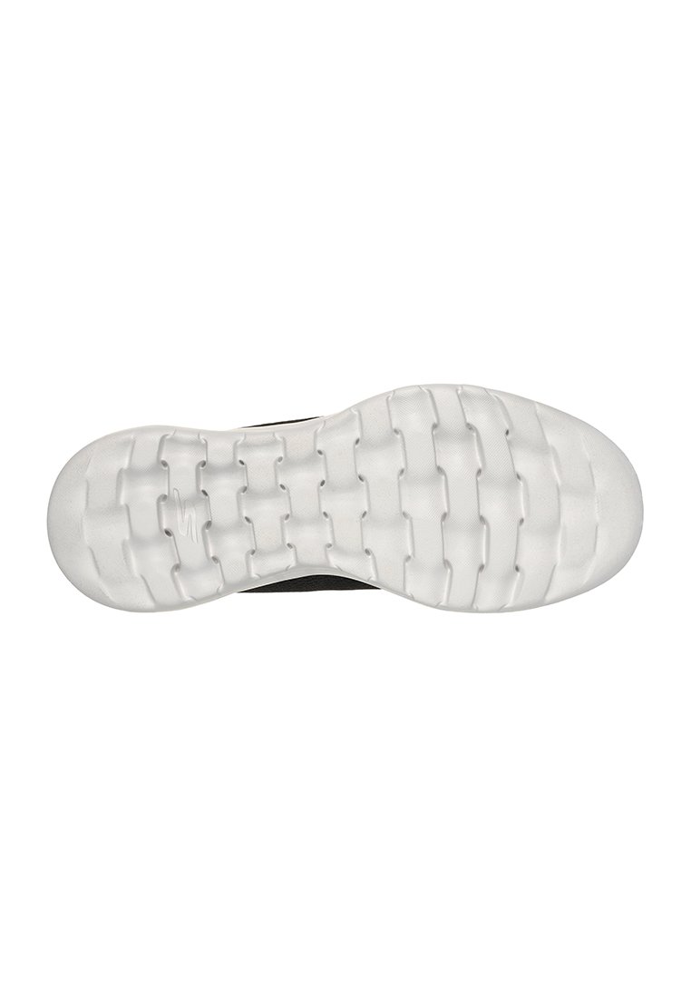 Suela de zapato negra con una superficie de goma texturizada blanca, que presenta ranuras flexibles y un patrón de banda de rodadura único para una mayor agarre y tracción.