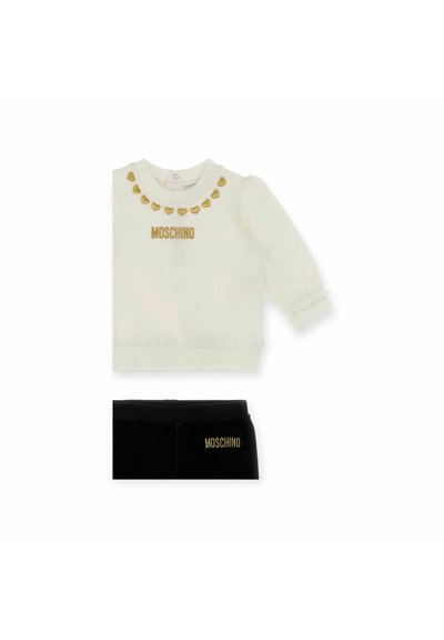 Hvid sweatshirt med guld hjerte accenter og "MOSCHINO" logo, parret med sorte fløjlsbukser med guld logo. Blødt materiale, ribbede manchetter.