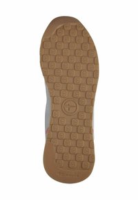 Sneakerzool met een gestructureerd tan rubberoppervlak met ovale patronen. De zijdetails bevatten een grijze bovenkant en roze accenten.