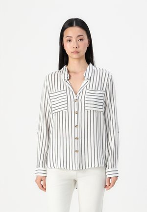 White button-up shirt with vertical black stripes, two chest pockets, and a collar. Long sleeves feature striped cuffs.