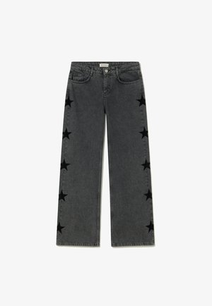 Vaqueros negros de pierna ancha con cintura alta y estampados de estrellas negras que recorren ambos lados exteriores de las piernas.