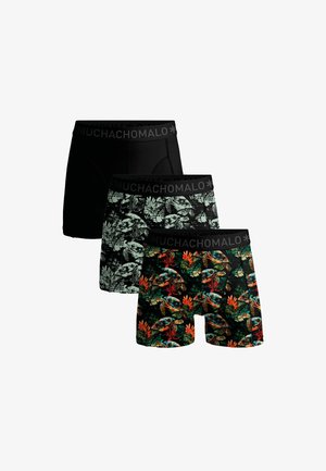 Trois boxers pour hommes avec ceintures noires étiquetées "MUCHACHOMALO", comprenant un modèle noir uni, un noir avec feuillage blanc, et un noir avec des motifs colorés de tortues et de corail.