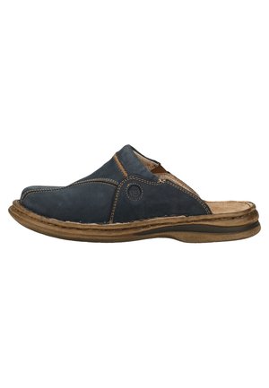 Navy blue slip-on shoe made of leather, featuring a rounded toe, contrasting stitching, and a cushioned insole with a brown rubber sole.