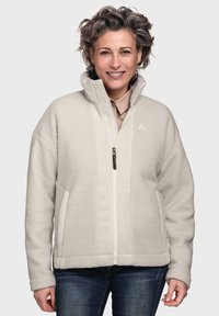 Cremfarbener Fleecepullover mit hohem Kragen, seitlichen Taschen und einem Reißverschluss auf der Vorderseite. Weiche Textur mit leicht erhabener und gemusterter Oberfläche.