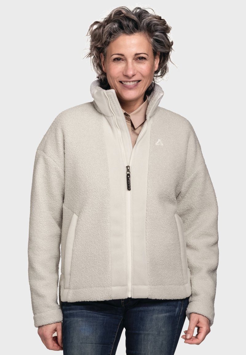 Cremfarbener Fleecepullover mit hohem Kragen, seitlichen Taschen und einem Reißverschluss auf der Vorderseite. Weiche Textur mit leicht erhabener und gemusterter Oberfläche.