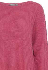 Pull en tricot rose avec un col large et un tissu texturé. Présente des manches amples et une coupe décontractée, idéal pour une tenue casual.