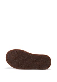 Semelle de chaussure en caoutchouc marron avec un motif texturé de logos et de symboles. La forme est arrondie à l'avant et plate au talon.